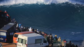 Tourists watching giant waves in Nazare Portugal